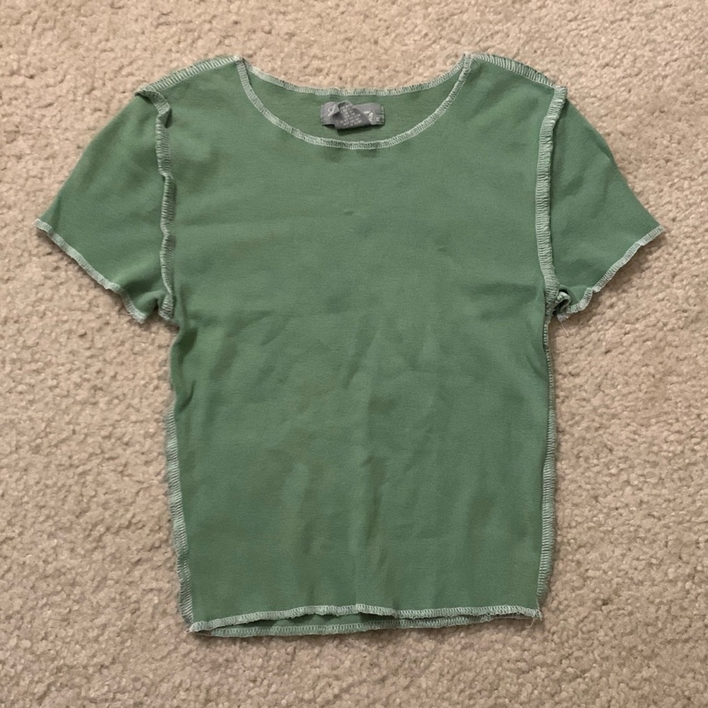 Tilly's green top with white stitching
